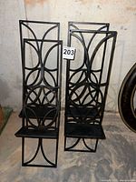 Front view showing two of the four black metal candle shelves