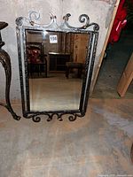 Full view showing ornate scrollwork frame and glass