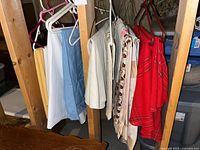 Assorted linens hanging on hangers showing colors and styles