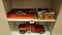 Overall lot showing two trays of cars and fire truck on shelf
