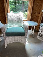 Front view of armchair with cushion and side table