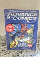 Front view of sealed Advance Comics book with Spider-Man hologram cover highlighting special hologram covers and limited edition cards.