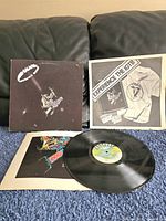 Full view of album cover, inner sleeve, vinyl record, and promotional insert on blue cloth.