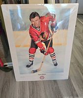 Full view of large print showing Stan Mikita in Chicago Blackhawks jersey posed on ice with hockey stick.