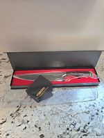 Jobosi chef's knife in original black gift box with red interior, handle and blade covered with protective wrap.
