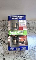 Photo of unopened Better Home Products Hall & Closet doorknob set box on countertop showing product images and brand.