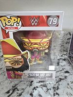 Front view of the boxed Macho Man Randy Savage WWE Funko Pop figure, showing figure inside with detailed colorful attire and packaging details.