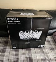 Box front showing Decor Living 3 Light Chandelier, crystal accent shade, polished chrome finish, model CRS-0066-CHR