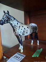 Full side view of Beswick appaloosa horse figurine on shelf