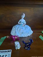 Group view of lady trinket box and three animal figurines