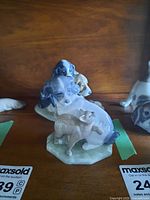 Front view of spaniel dog with kitten figurine