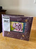 Album cover showing pink elephant miniature art card in front pocket