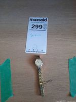 Watch beside lot card showing full length