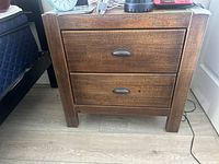 Front view showing two drawers, rustic finish, metal pulls