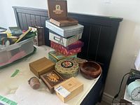 Overall lot showing stacked tins, wood boxes, bowl and small container