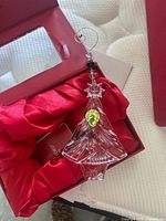 Ornament in satin-lined box with hanger visible