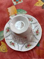 Bottom view of Royal Albert teacup resting on matching saucer showing maker's mark and floral pattern on saucer