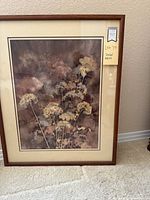 Frontal image of framed watercolor artwork showing botanical floral design with muted purple and brown background.