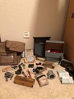 Full view of the assembled collection of military items showing various gear and tools arranged on the floor.