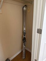 Full view of one Volant Vertex T3 ski leaning against closet wall, showing length and binding attached.