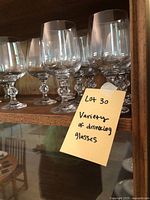 7 light brown tint drinking glasses with rounded bowl and decorative stem, about 5 inches tall