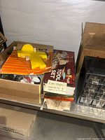 Boxes of model craft items and crafting tools with visible packaging showing 'Tool Set' and label with lot number.