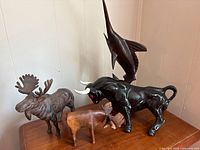 All four figurines grouped on tabletop