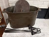 Overall view of copper tub, ash shovel, and two cone snuffers