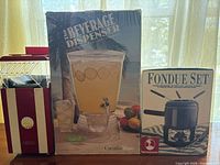 Popcorn maker, beverage dispenser box, fondue set box