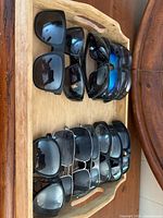 All sunglasses arranged in wooden tray