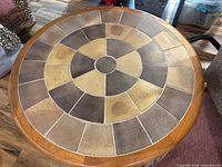 Overhead view showing full mosaic tile pattern and wood rim