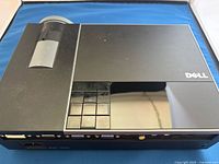 Top view of Dell 1209S projector showing lens cover and control keypad