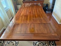 Top view of full table with both leaves installed showing wood grain and minor wear
