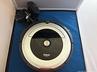 Top view of iRobot Roomba 600 Series vacuum with charging base