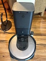 iRobot Clean Base dock with Roomba vacuum positioned for scale and condition