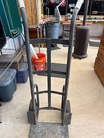Full front view of metal hand truck showing handles and frame