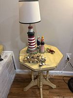 Overall view of lamp, figurines, floats, lobster and octagonal table