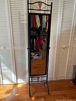 Full view of freestanding mirror showing frame, wicker heart, and legs