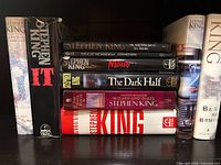 Left stack showing eight Stephen King hardcovers including IT and Misery