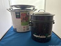 Stainless steel stock pots and enamelware steamer grouped
