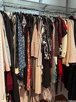 Full rack of assorted women’s garments on hangers