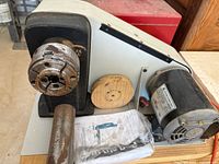 Lathe headstock with chuck, motor housing, faceplate and manual in plastic