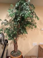 Full view of artificial tree in planter