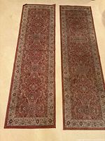 Both runner rugs laid side by side showing full patterns and colour