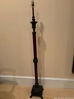 Full view of lamp without shade, showing wood column and metal base