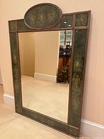 Full front view showing mirror, oval pediment and painted green panels