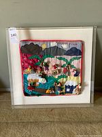 Full view of framed textile art in acrylic box frame