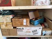 shelving with several labeled boxes and visible green string lights