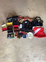 Overall lot showing backpack, totes, cases, wallets, accessories