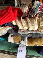 Stack of assorted sweaters showing colours and textures